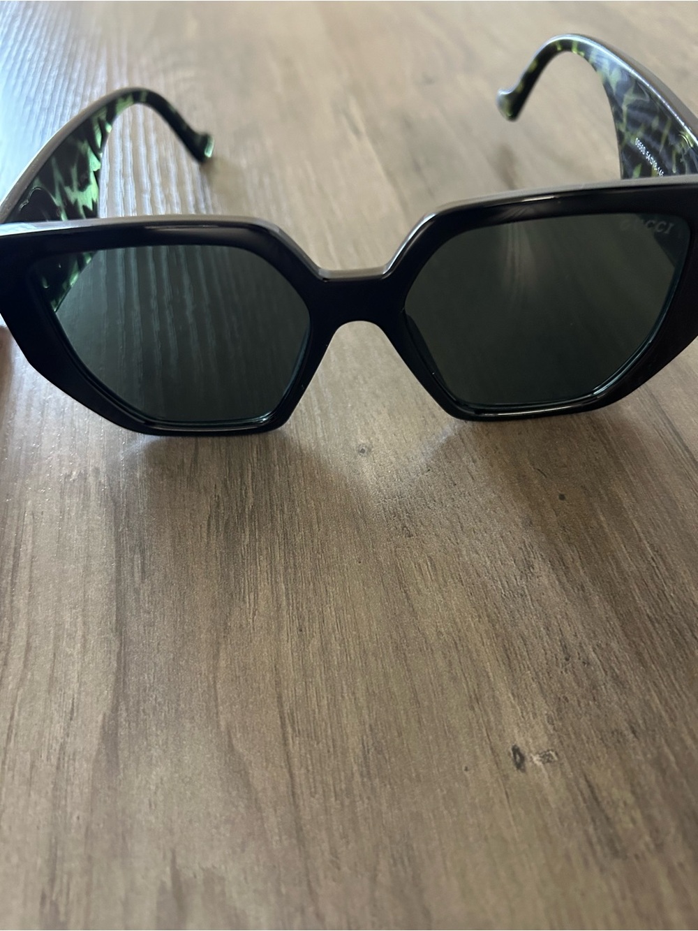 Black Cat-Eye Sunglasses with Green Lens and Temple Accents